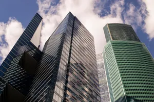 A dramatic view of Moscow's modern skyscrapers against a bright sky, showcasing urban architecture. jigsaw puzzle