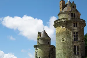 Two round castle towers rise majestically under a bright blue sky, showcasing medieval architecture. jigsaw puzzle