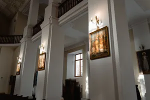 Sunlit interior of a historic church featuring classic religious paintings. jigsaw puzzle