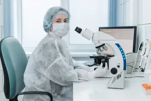 Woman lab technician examining samples with a trinocular microscope in a medical laboratory setting. jigsaw puzzle