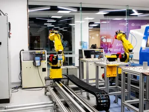 Robotic arms in action within a modern industrial control room setting, showcasing technology and production. jigsaw puzzle