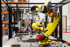 Close-up of a yellow industrial robotic arm in action at a modern manufacturing facility. jigsaw puzzle