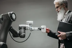 An elderly man receives a cup from a robotic arm in a modern office setting. jigsaw puzzle