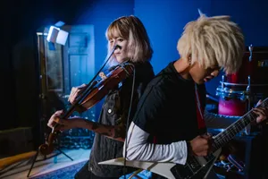 Energetic music rehearsal with violin and electric guitar under studio lighting. jigsaw puzzle