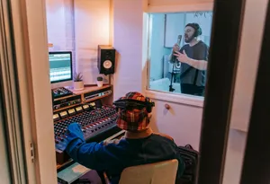 Musicians recording a song in a modern studio with audio engineer at mixing console. jigsaw puzzle