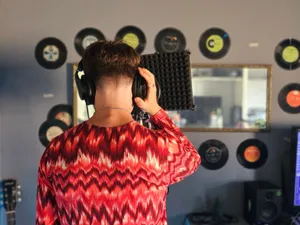 Back view of a young musician recording vocals in a home studio. jigsaw puzzle