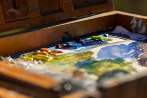 A vibrant artist's paint palette with various colors in an outdoor setting. jigsaw puzzle