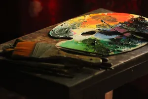 Colorful artist palette with paintbrushes on a wooden table, capturing creative energy. jigsaw puzzle