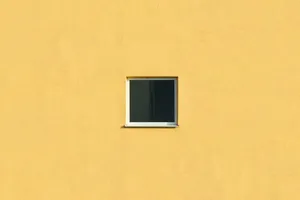 A small isolated window on a vibrant yellow wall offers minimalist architectural design. jigsaw puzzle