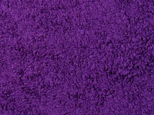 A detailed close-up of a purple textured fabric, showcasing the intricate pattern and soft texture. jigsaw puzzle