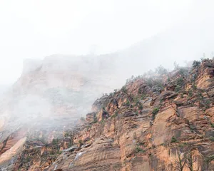 Misty mountain cliffs with sparse vegetation jigsaw puzzle