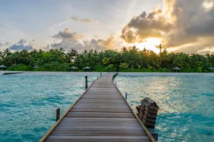 brown wooden dock on blue sea under white clouds during daytime jigsaw puzzle
