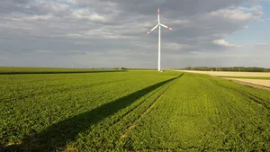 a wind turbine in the middle of a green field jigsaw puzzle