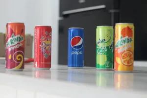 a row of soda cans sitting on top of a counter jigsaw puzzle