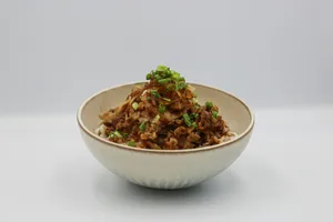 a white bowl filled with food on top of a table jigsaw puzzle