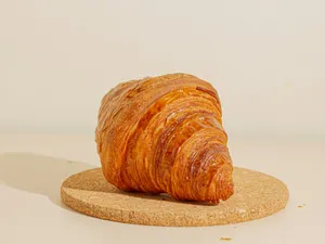 a piece of bread sitting on top of a cork coaster jigsaw puzzle
