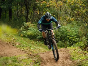a man riding a bike down a dirt road jigsaw puzzle