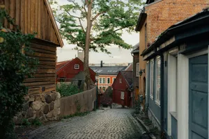 Cobblestone street lined with historic wooden and brick buildings. jigsaw puzzle