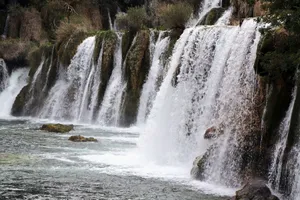 Stunning waterfalls cascading amidst lush greenery at Krka National Park in Croatia. jigsaw puzzle