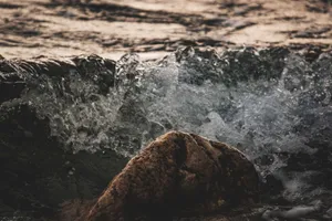 Close-up of a wave crashing against rock at seaside, showcasing nature's power. jigsaw puzzle