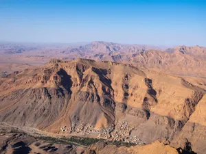 A breathtaking aerial view of the desert and rocky formations near Tata, Morocco under a blue sky. jigsaw puzzle