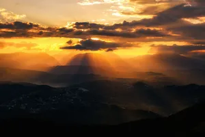 A breathtaking sunrise over Sochi mountains with rays of light filtering through clouds. jigsaw puzzle