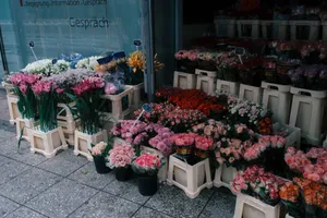 Colorful flower display on a European sidewalk with diverse bouquets outside a shopfront. jigsaw puzzle