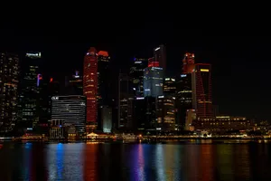 Vibrant nighttime cityscape of Singapore's illuminated skyline reflecting on water. jigsaw puzzle