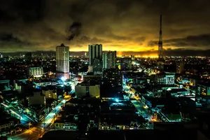 Stunning night view of Quezon City skyline with illuminated buildings and vibrant city lights. jigsaw puzzle