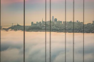 Dramatic view of San Francisco skyline shrouded by fog and framed by Golden Gate Bridge cables. jigsaw puzzle