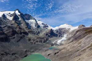 Stunning alpine landscape showcasing glaciers and a turquoise river under a clear blue sky. jigsaw puzzle