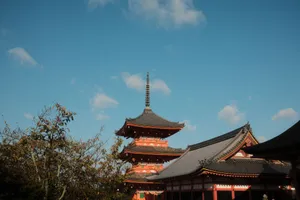Stunning view of a traditional Japanese pagoda in Kyoto with a clear blue sky. jigsaw puzzle