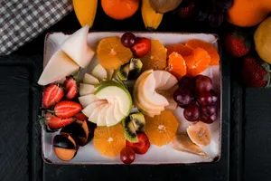 Colorful assortment of sliced fresh fruits on a decorative plate, perfect for healthy snacking. jigsaw puzzle