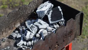 A detailed close-up of charred coals in an outdoor grill, showcasing high heat and barbecue readiness. jigsaw puzzle