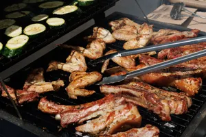 Delicious barbecue chicken and zucchini grilling outdoors on a sunny day. jigsaw puzzle