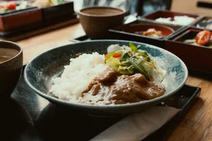 A close-up of a Japanese curry rice dish with salad served in a ceramic bowl. jigsaw puzzle