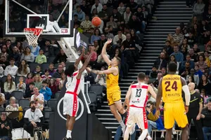 Dramatic moment in a basketball game with players and an engaged crowd. jigsaw puzzle