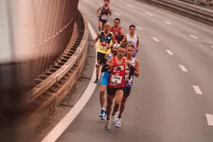 A group of male athletes competing in a city marathon, featuring diverse runners and dynamic movement. jigsaw puzzle