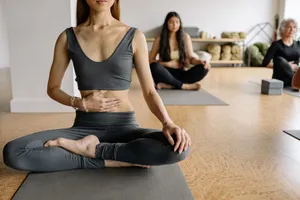 Women practicing yoga and meditation in a studio setting. Calm and focused atmosphere. jigsaw puzzle