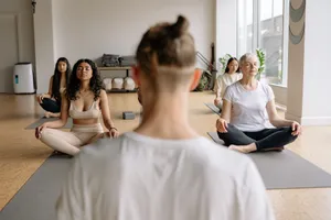 Peaceful meditation session with diverse group practicing yoga indoors. jigsaw puzzle