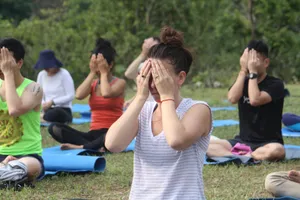 Group practicing yoga meditation outdoors at a retreat in Rishikesh, India. jigsaw puzzle