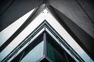 A low-angle view of a modern building with glass and steel design, showcasing urban architecture. jigsaw puzzle