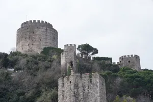 A medieval stone fortress surrounded by lush greenery, showcasing historical architecture amidst nature. jigsaw puzzle