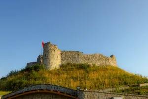 Explore the historic Rize Castle in Türkiye, standing majestically on a hill under a bright blue sky. jigsaw puzzle