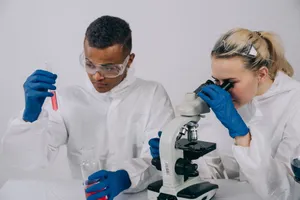 Two scientists in a lab focusing on experiments using a microscope and test tube. jigsaw puzzle