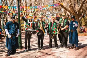 Colorful street band with clowns playing music in a festive outdoor setting. jigsaw puzzle