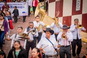 Vibrant street parade featuring a brass band performance with male and female participants. jigsaw puzzle