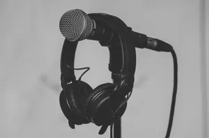 Black and white close-up of a microphone and headphones on a stand, perfect for music and recording studio themes. jigsaw puzzle