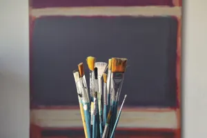 A set of paintbrushes in front of an abstract canvas, reflecting creativity and inspiration. jigsaw puzzle