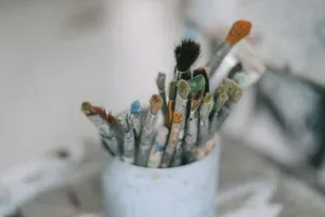 Assorted paintbrushes in a container for artistic creativity and painting. jigsaw puzzle